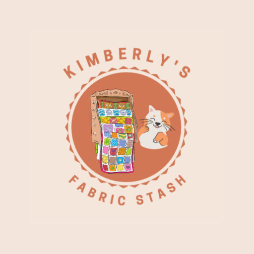 Kimberly’s Quilt Shop logo featuring a quilt and cat representing quilt fabric and learning